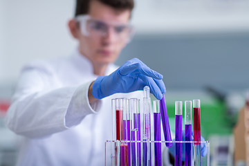 Image showing student with protective glasses making chemistry experiment