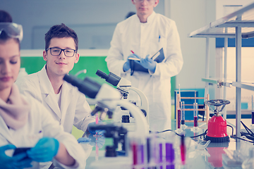 Image showing Group of young medical students doing research