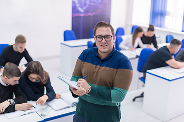 Image showing male student with others writing notes