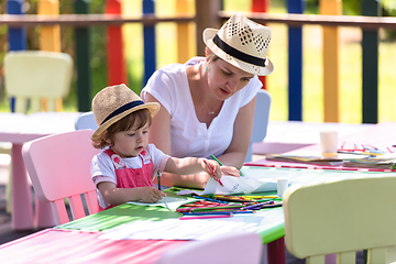 Image showing mom and little daughter drawing a colorful pictures