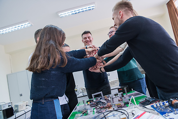 Image showing students celebrating successfully finished project