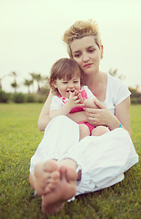 Image showing mother and little daughter playing at backyard