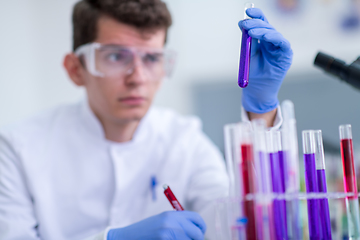 Image showing student with protective glasses making chemistry experiment