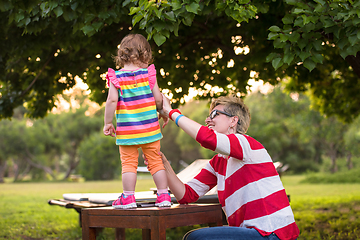 Image showing mom and her little daughter using tablet computer