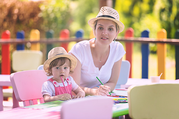 Image showing mom and little daughter drawing a colorful pictures