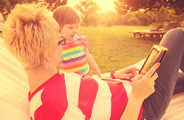 Image showing mom and a little daughter relaxing in a hammock