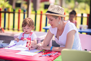 Image showing mom and little daughter drawing a colorful pictures