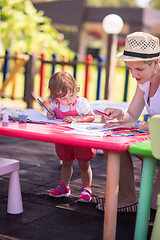 Image showing mom and little daughter drawing a colorful pictures