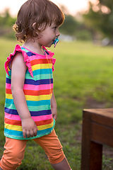 Image showing little girl spending time at backyard