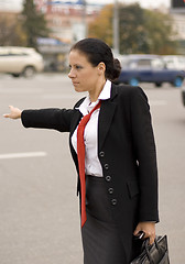 Image showing hitchhiking businesswoman 