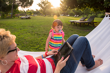 Image showing mom and a little daughter relaxing in a hammock