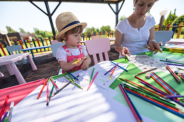 Image showing mom and little daughter drawing a colorful pictures