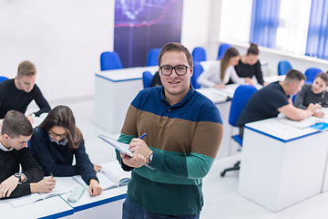 Image showing male student with others writing notes