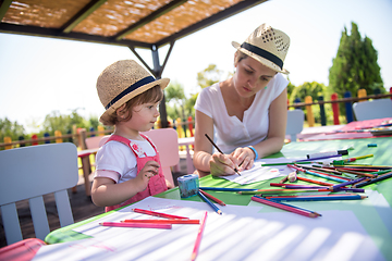 Image showing mom and little daughter drawing a colorful pictures