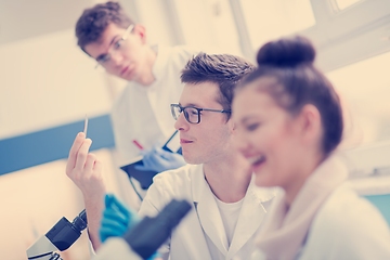 Image showing Group of young medical students doing research