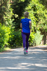 Image showing young female runner training for marathon