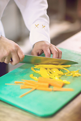 Image showing Chef hands cutting fresh and delicious vegetables