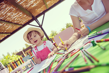 Image showing mom and little daughter drawing a colorful pictures