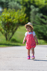 Image showing little girl runing in the summer Park