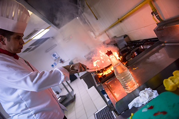 Image showing Chef doing flambe on food