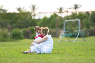 Image showing mother and little daughter playing at backyard