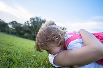 Image showing mother and little daughter playing at backyard