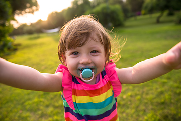 Image showing little girl spending time at backyard