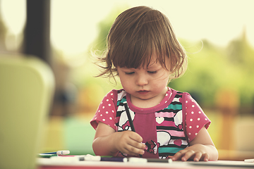 Image showing little girl drawing a colorful pictures