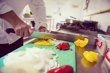 Image showing Chef hands cutting fresh and delicious vegetables