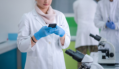 Image showing woman scientist using smartphone