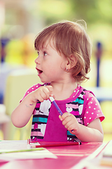 Image showing little girl drawing a colorful pictures