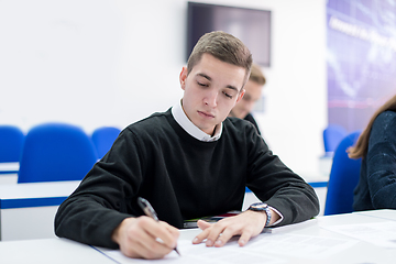 Image showing male student writing notes