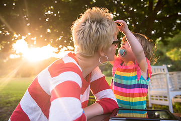 Image showing mom and her little daughter using tablet computer