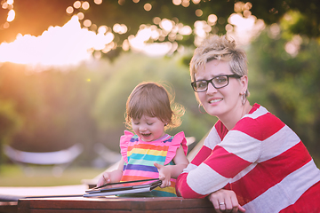 Image showing mom and her little daughter using tablet computer