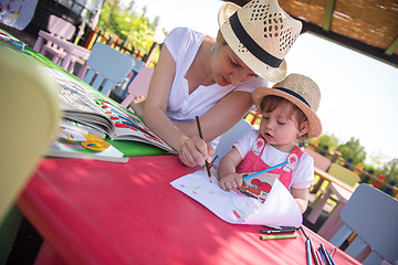 Image showing mom and little daughter drawing a colorful pictures