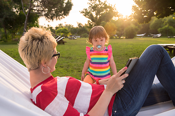 Image showing mom and a little daughter relaxing in a hammock