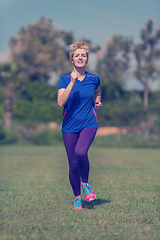 Image showing young female runner training for marathon