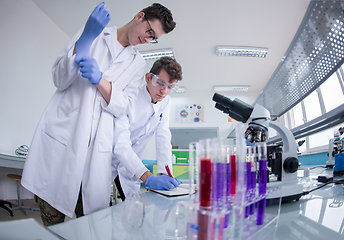 Image showing Group of young medical students doing research