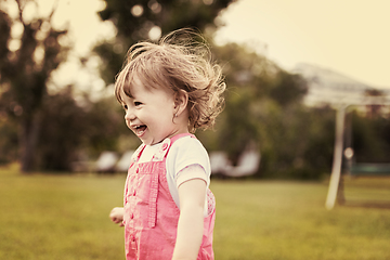 Image showing little girl spending time at backyard