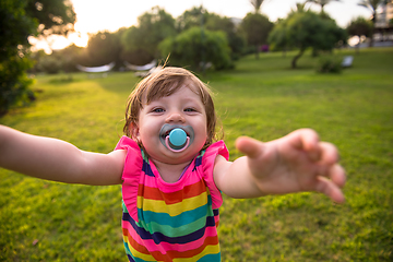 Image showing little girl spending time at backyard