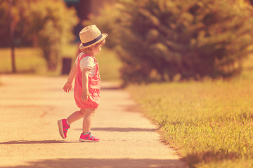 Image showing little girl runing in the summer Park