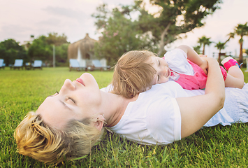 Image showing mother and little daughter playing at backyard