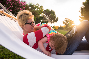 Image showing mom and a little daughter relaxing in a hammock