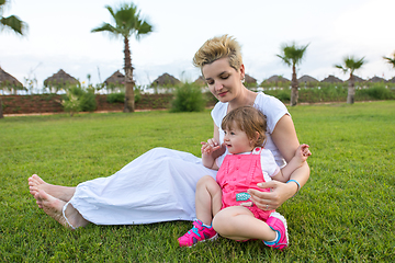 Image showing mother and little daughter playing at backyard