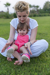 Image showing mother and little daughter playing at backyard