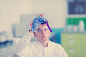 Image showing student with protective glasses making chemistry experiment