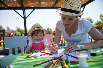 Image showing mom and little daughter drawing a colorful pictures