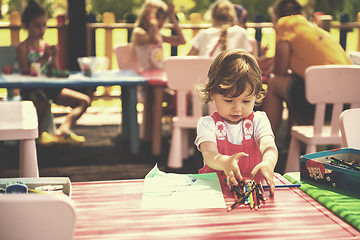 Image showing little girl drawing a colorful pictures