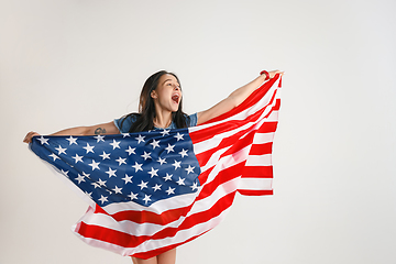 Image showing Young woman with the flag of United States of America