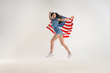 Image showing Young woman with the flag of United States of America